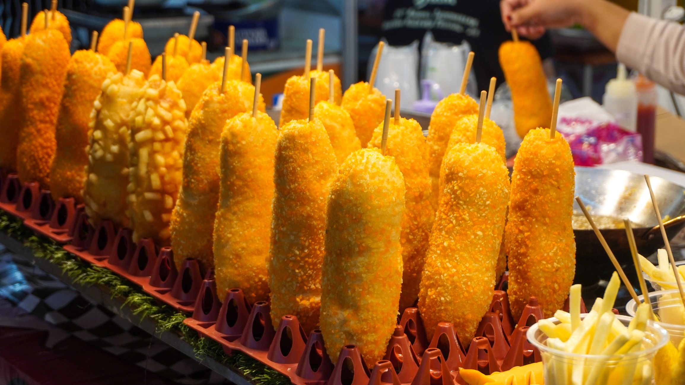 A crispy Korean corn dog with a mozzarella cheese pull